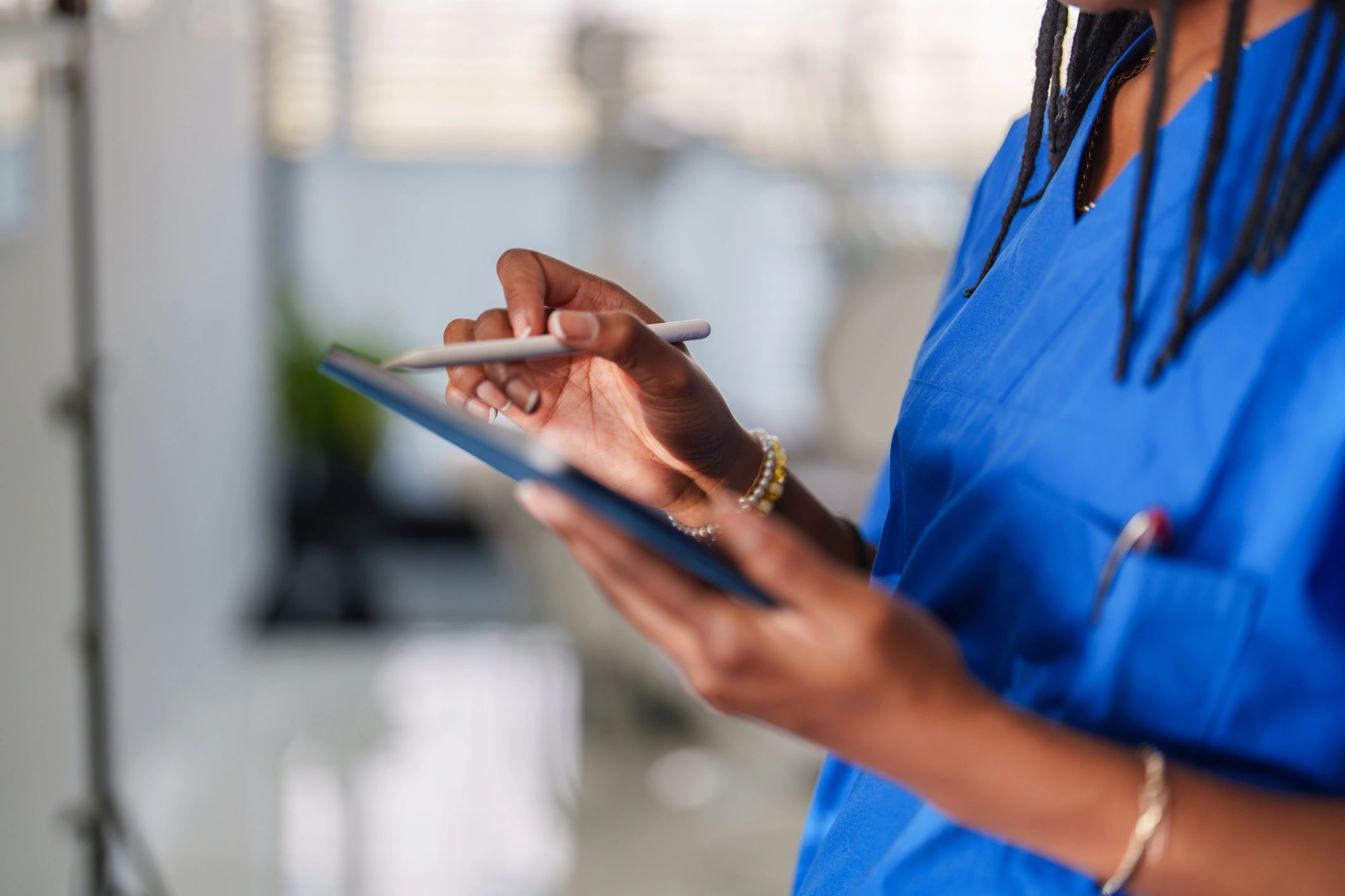 Healthcare worker using a digital tablet