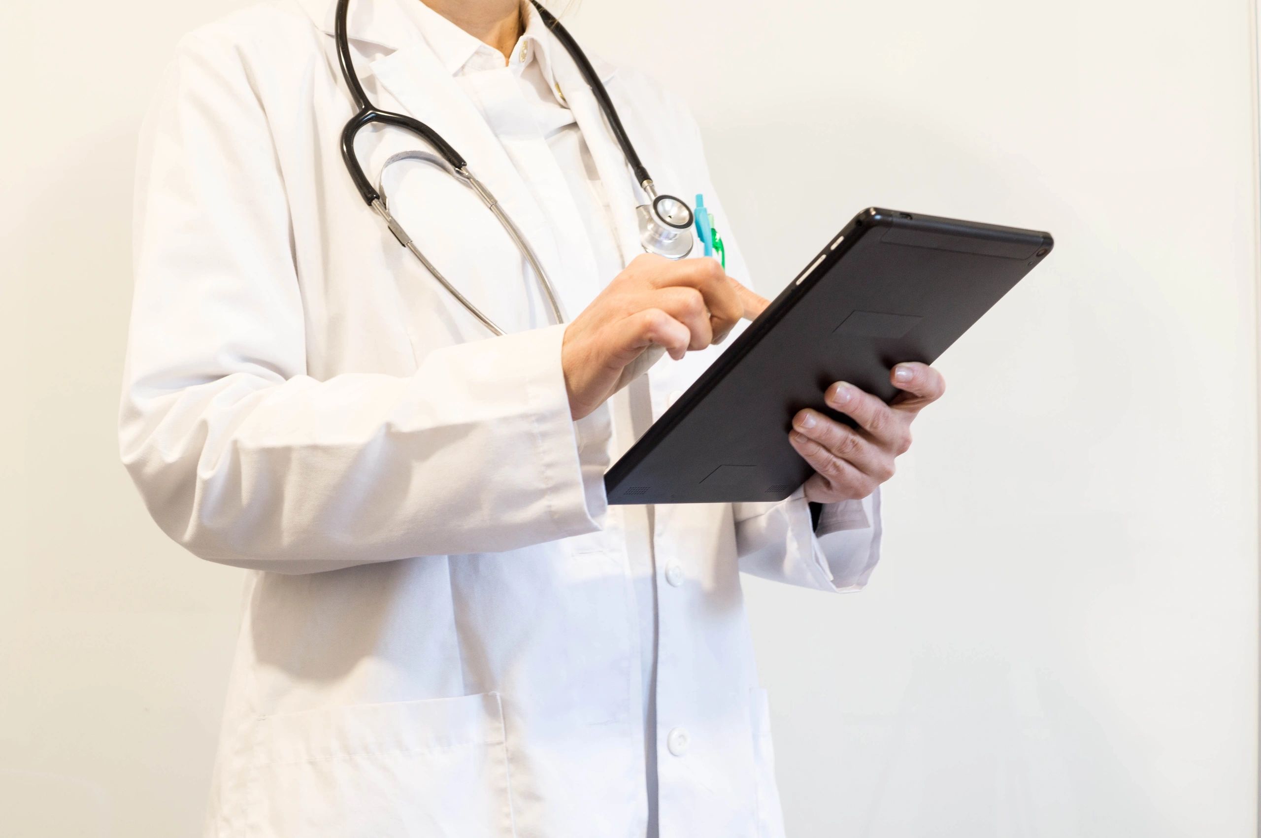 Clinician using a tablet for digital healthcare workflow